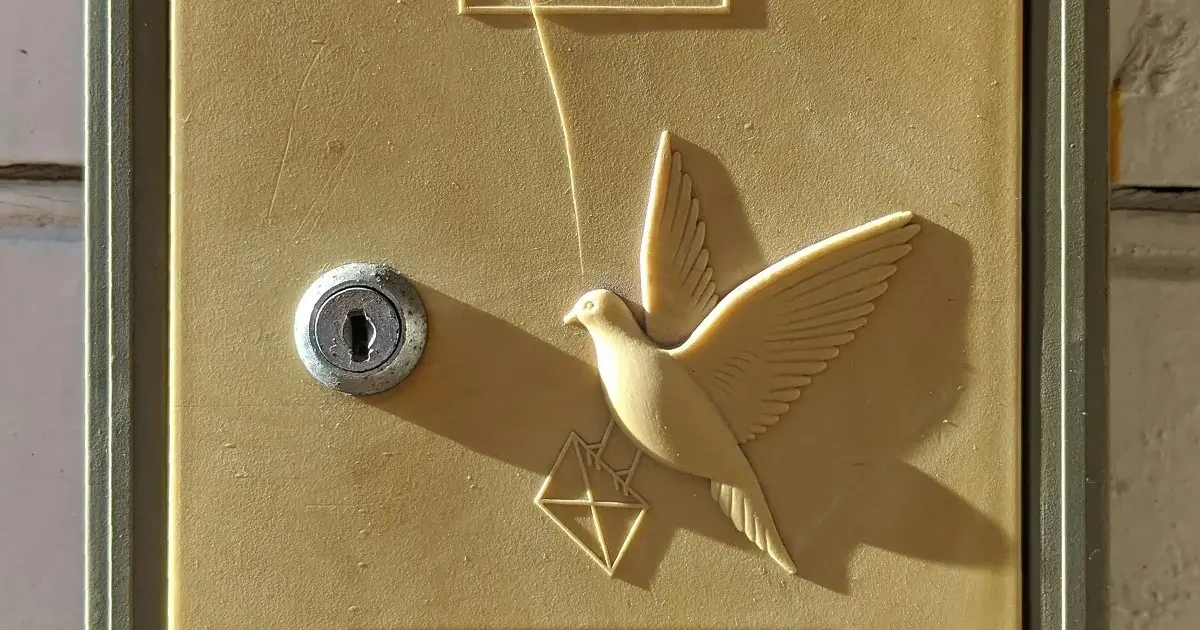 A mailbox with a carrier pigeon.
