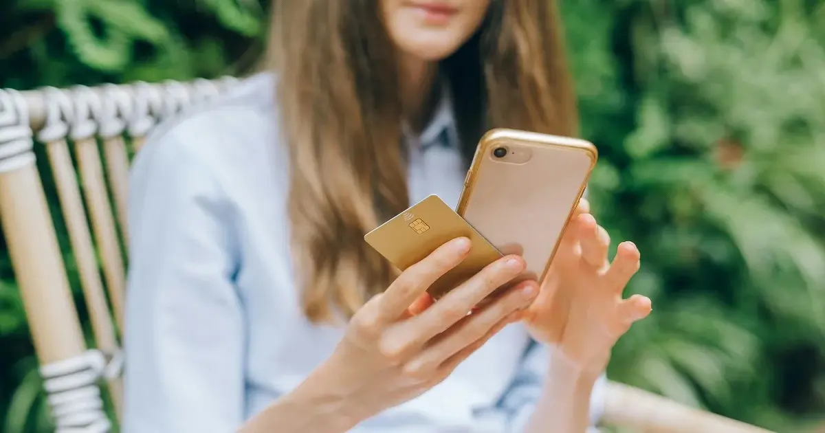 A girl with a phone making an online transaction.