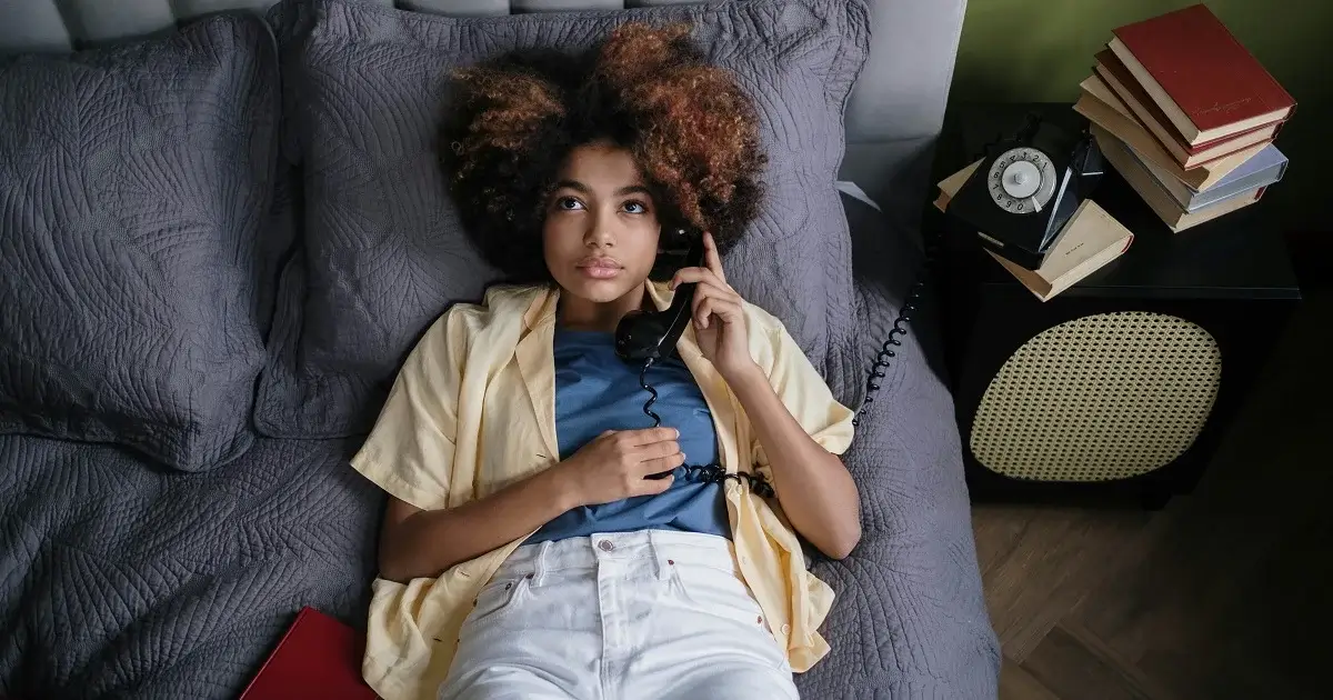 A girl on bed waiting in a phone call.