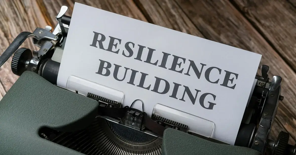 A typewriter writing the word resilience.